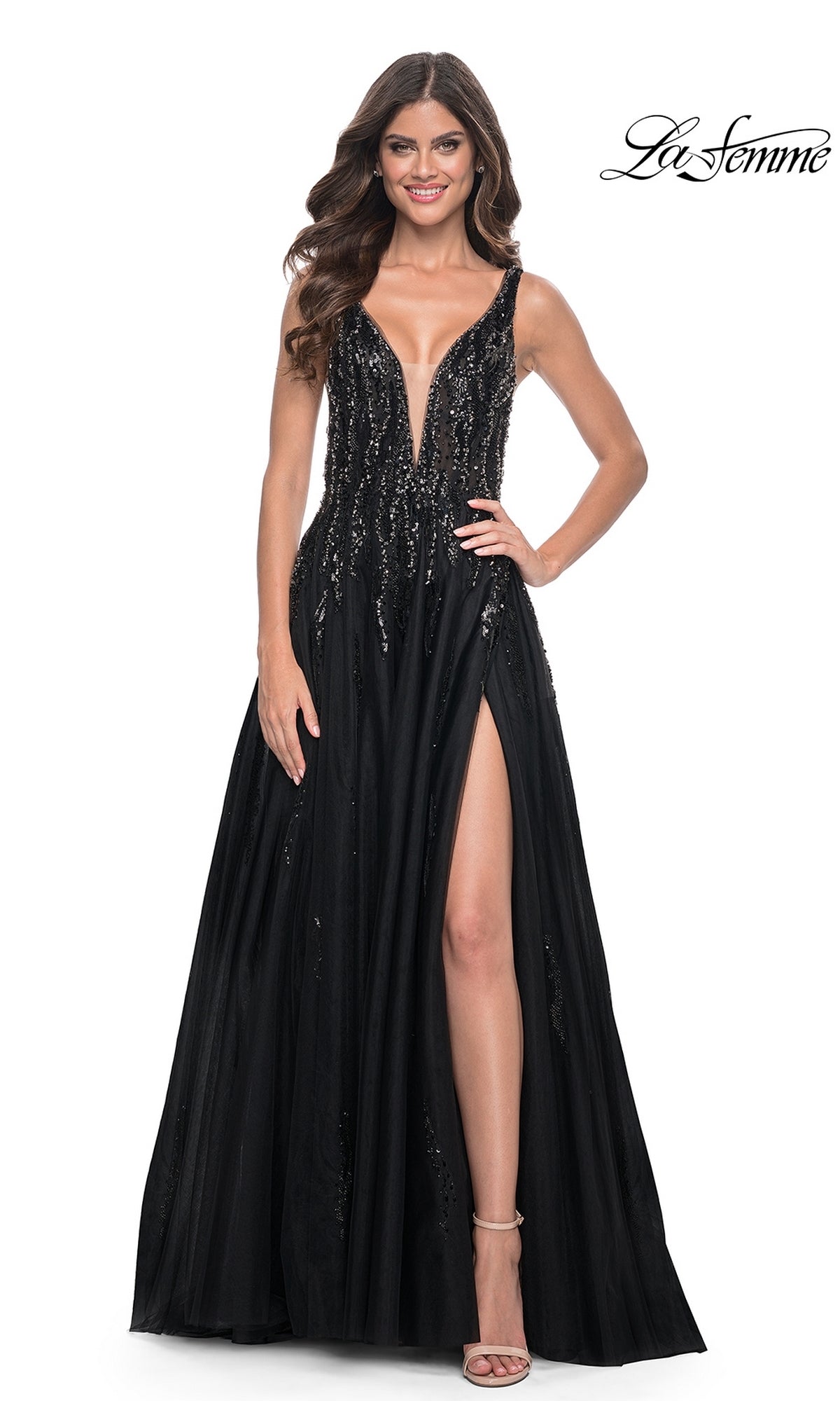 A woman models the La Femme Deep V-Neck Long Black Prom Dress 32345, featuring sequin embellishments and a high slit, standing against a plain white background.